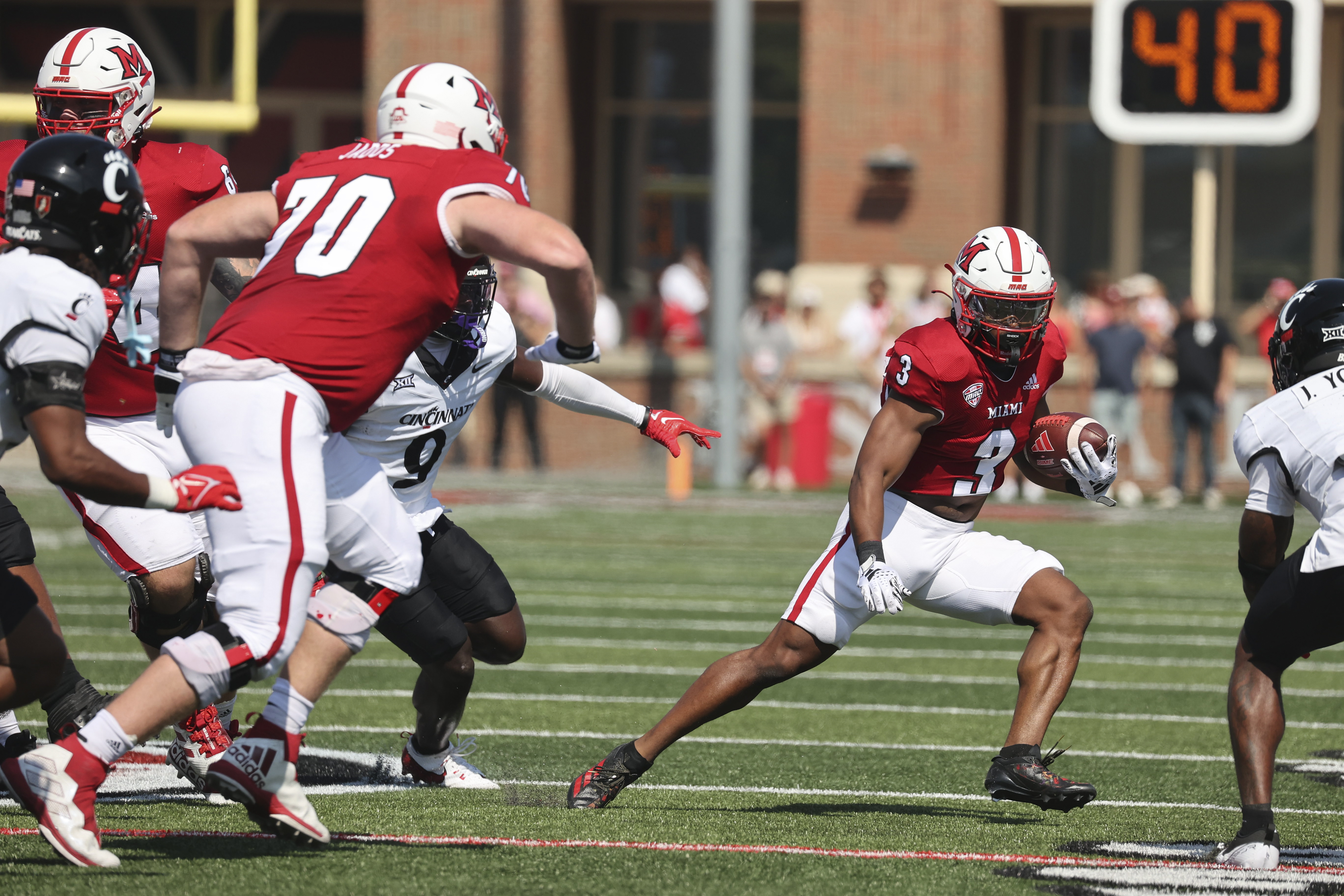 Miami's Keyon Mozee (3) runs the ball against Cincinnati on Sept. 14.