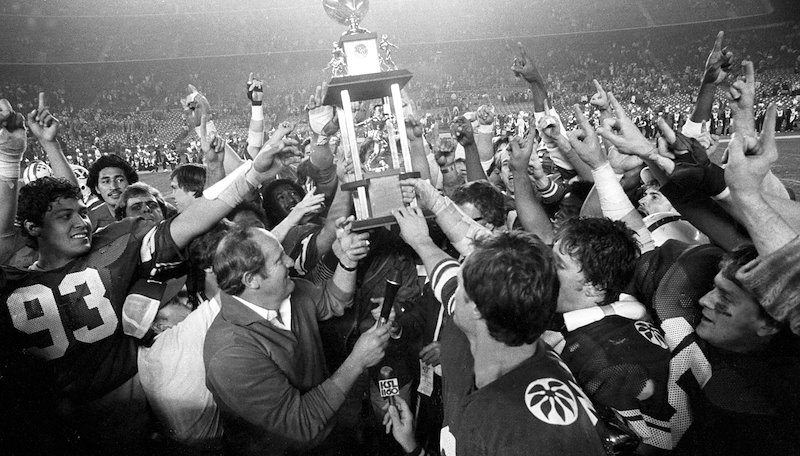 1980 team celebrating with the Holiday Bowl trophy.