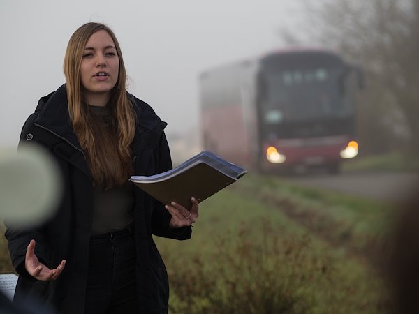 Caitlyn Graovac portrays Private Elton Mackin in wheatfield during a stop on their trip.