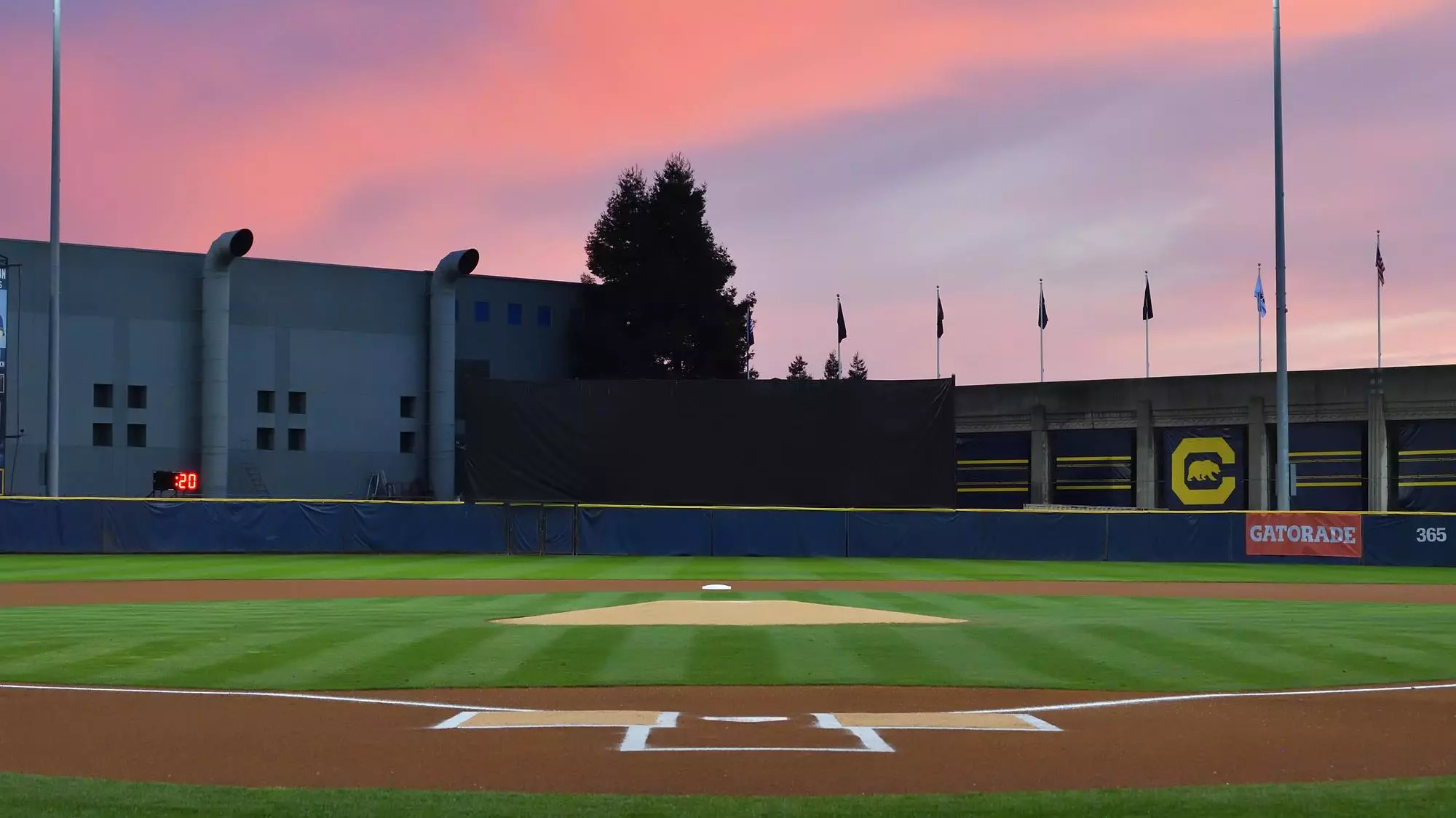 Cal Alumni Baseball field at sunset. Pink and purple sky above the ...