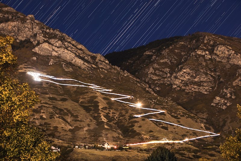 Students carrying LED lamps create a trail of light on the Y during BYU's homecoming - Time Lapse Photo by Aaron Cornia/BYU Photo