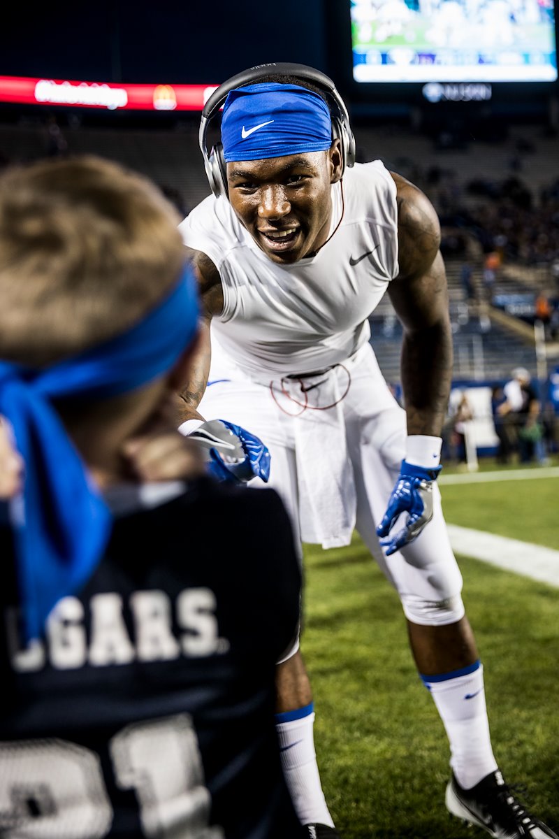 Jamaal Williams talks to a young fan before the game against Mississippi State - Photo by Jaren Wilkey/BYU