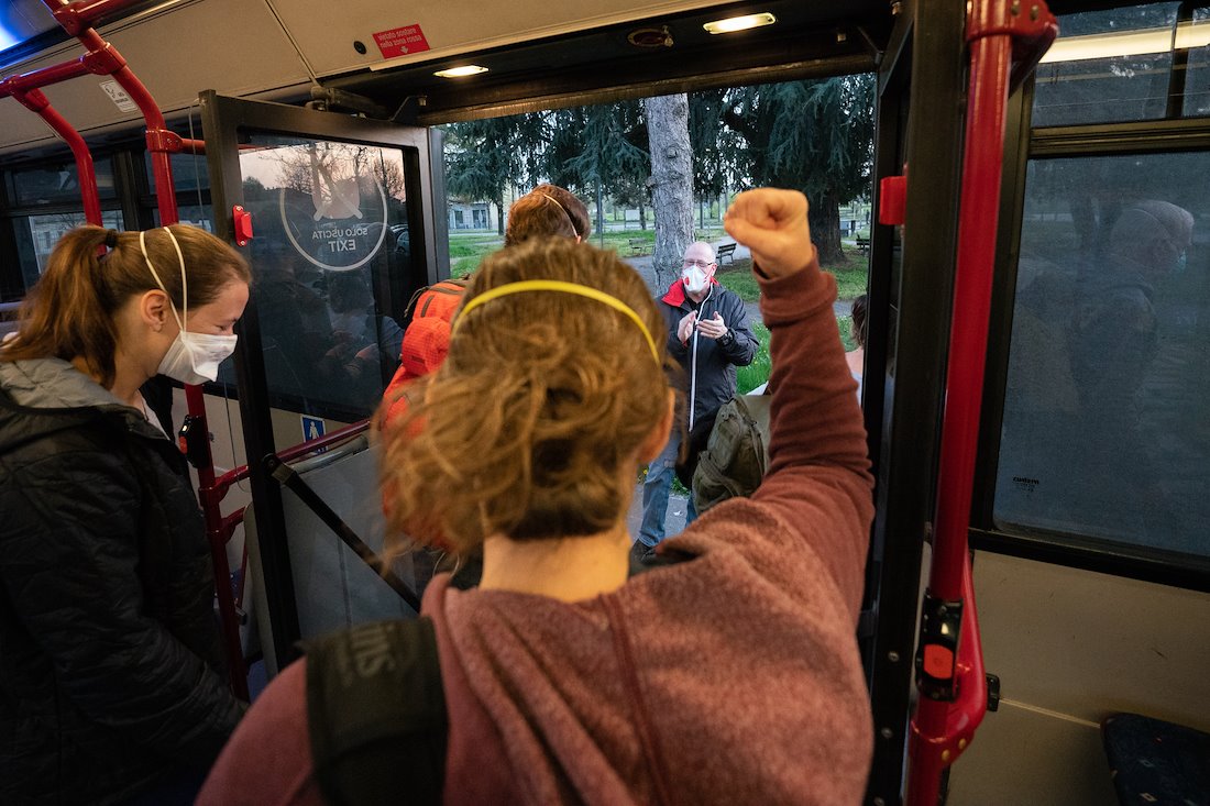 As they arrive on a bus to start work, the night shift is applauded by the day shift.
