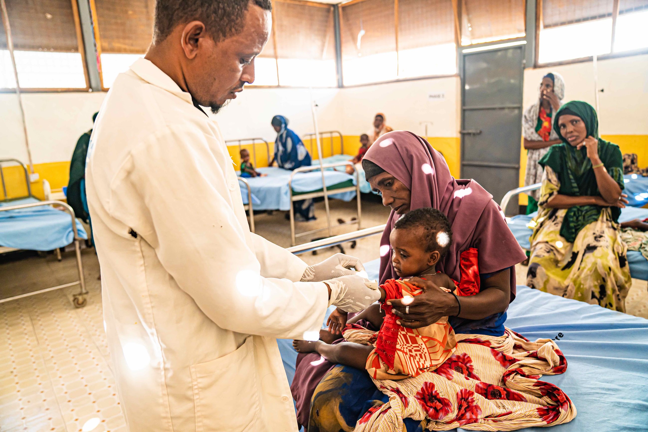 Asdikarim assesses a malnourished child at the Doolow Referral Health Centre.