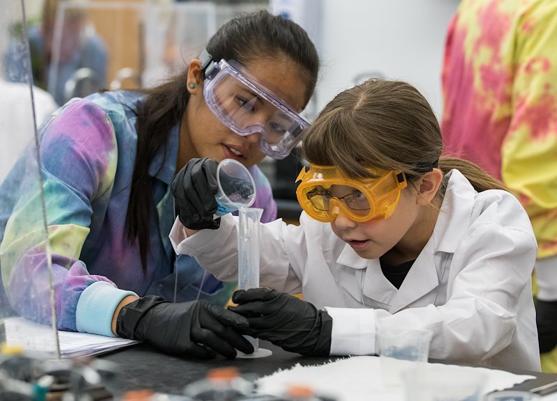 BYU student helps youngster at BYU Chem Camp - Photo by Jaren Wilkey/BYU