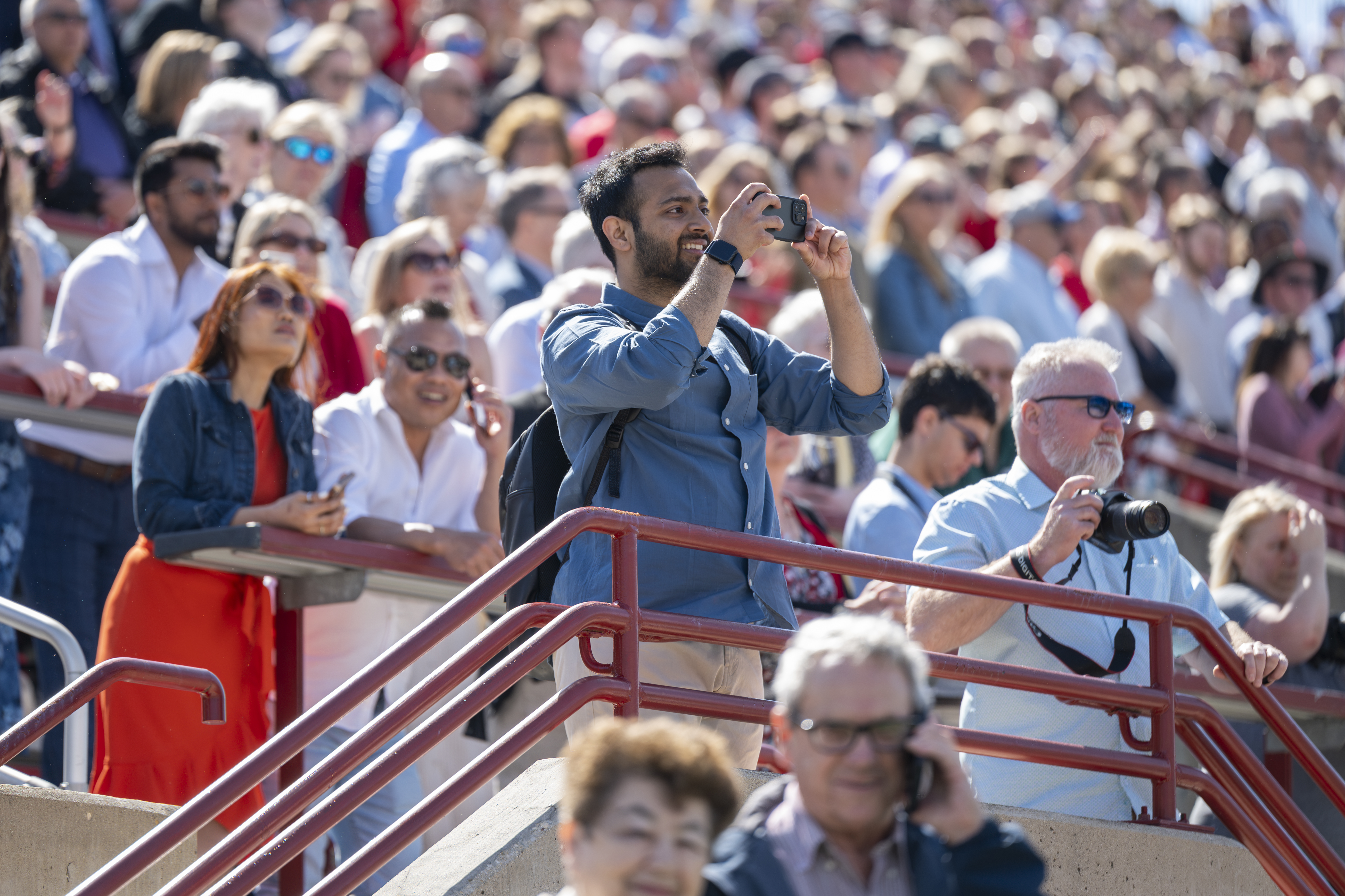 Members of the crowd have their cameras ready during the May 17 ...