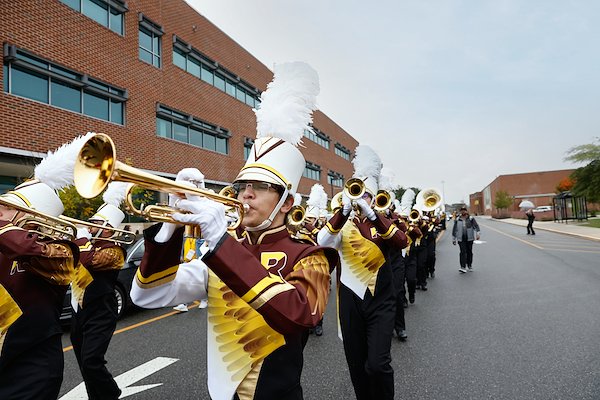 During pre-game celebrations, the Pride of the Profs led the torch team in a spirited march near the stadium area.
