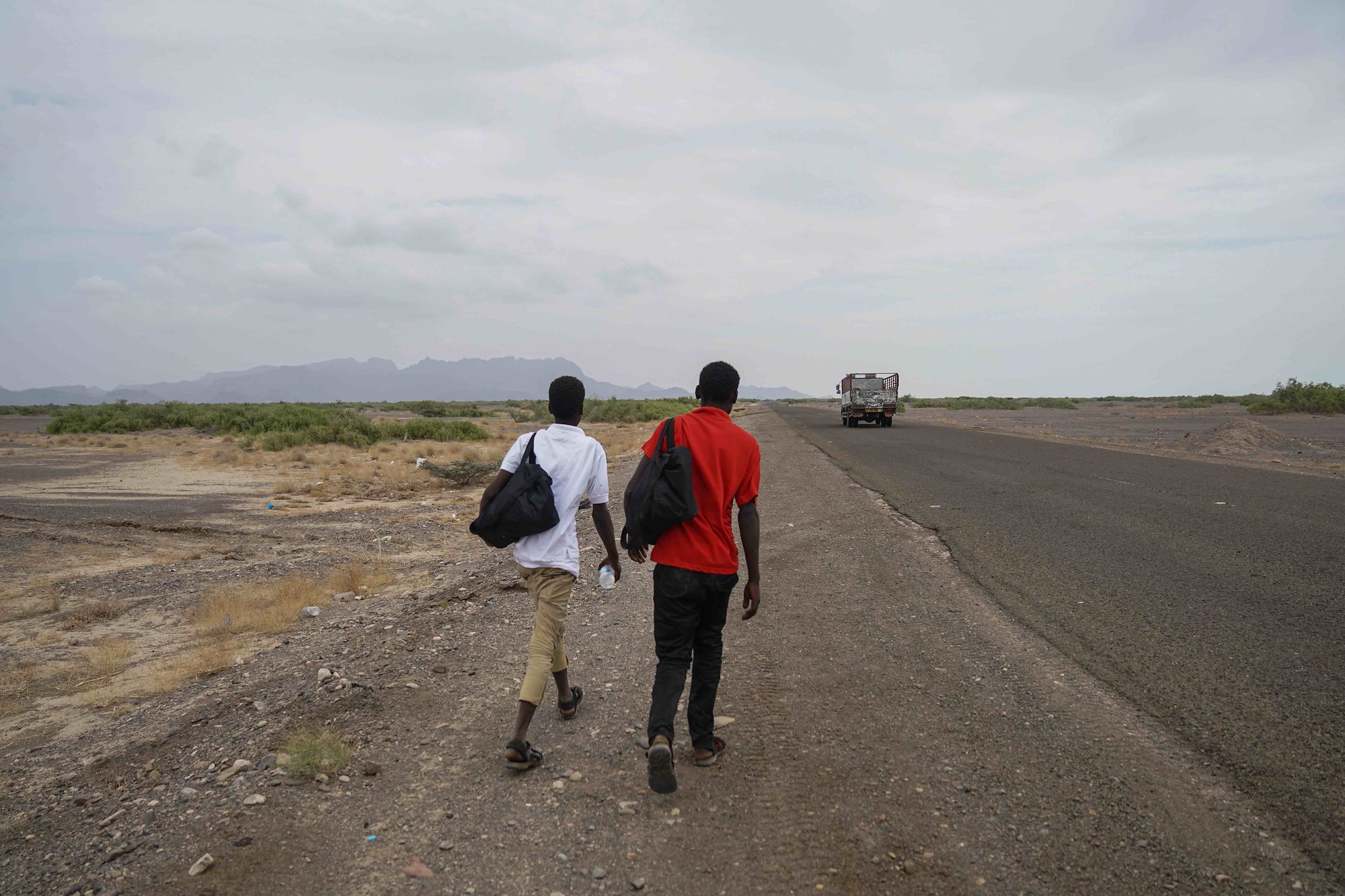 Two Ethiopian men, aged 15 and 17, walk the long road towards Aden from Ras-al-Ara, some 150 km to the east. They arrived a week earlier from Djibouti by smuggler boat.