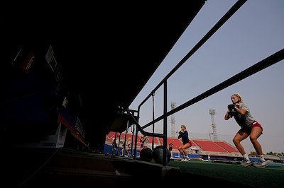 Haley and Hanna Cavinder exercise on Pete Beiden Field at Bob Bennett Stadium.