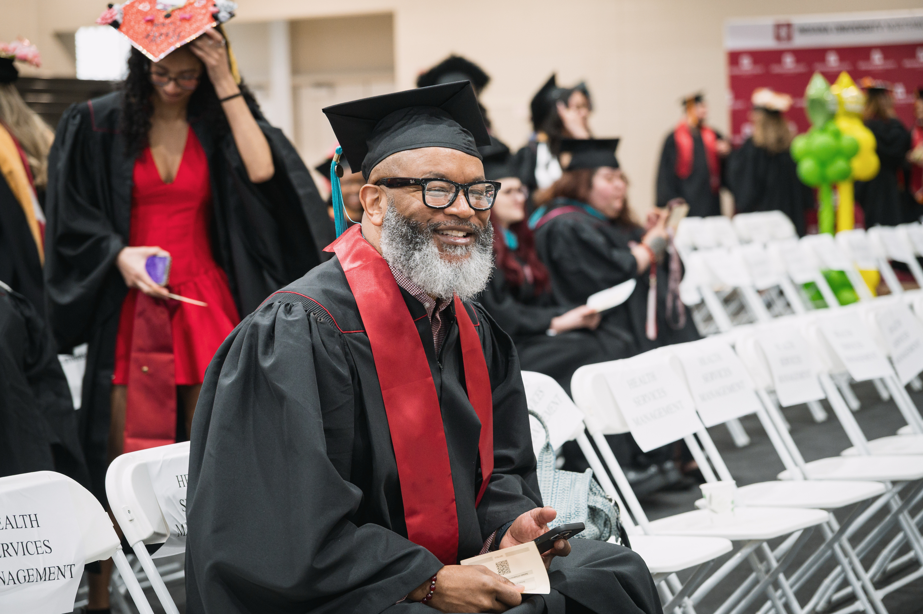 A graduate waits for the start of the IU Northwest Commencement in Gary ...