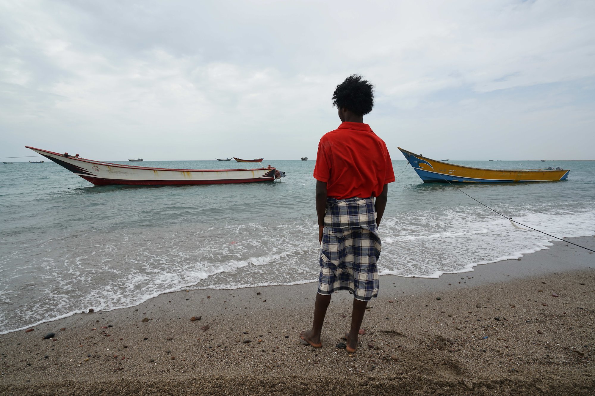 A young Ethiopian man on a notorious smugglers’ beach on Yemen's remote southern coast.