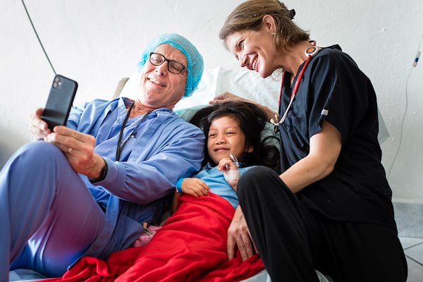 Sherly  smiles with Drs. Judd and Judy following her surgery.