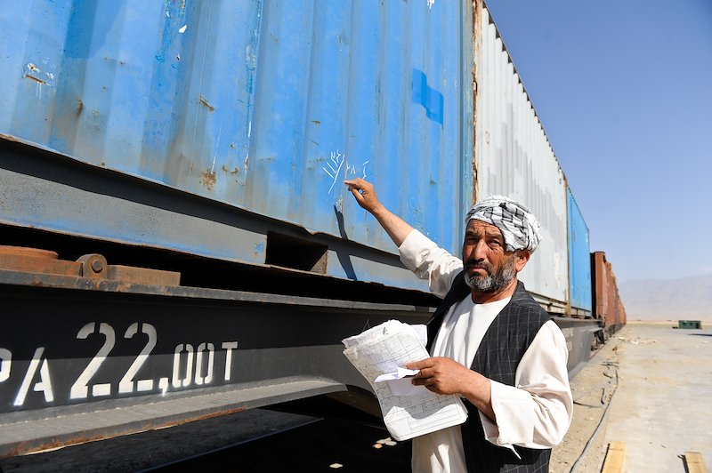 An inspector marking containers in Mazar-i-Sharif.