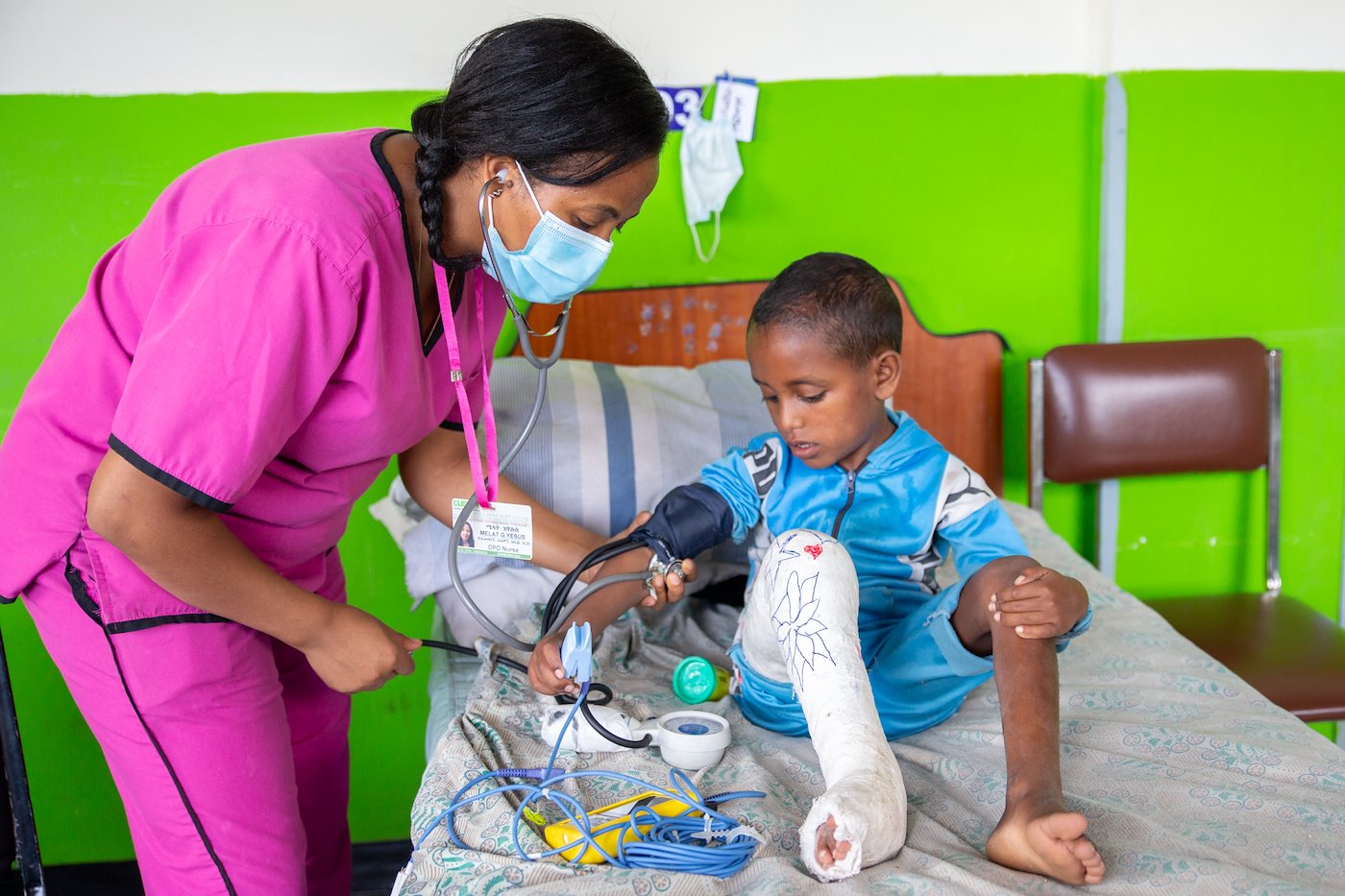 A typical scene at CURE Ethiopia. Our nurses checking the patient's vitals.