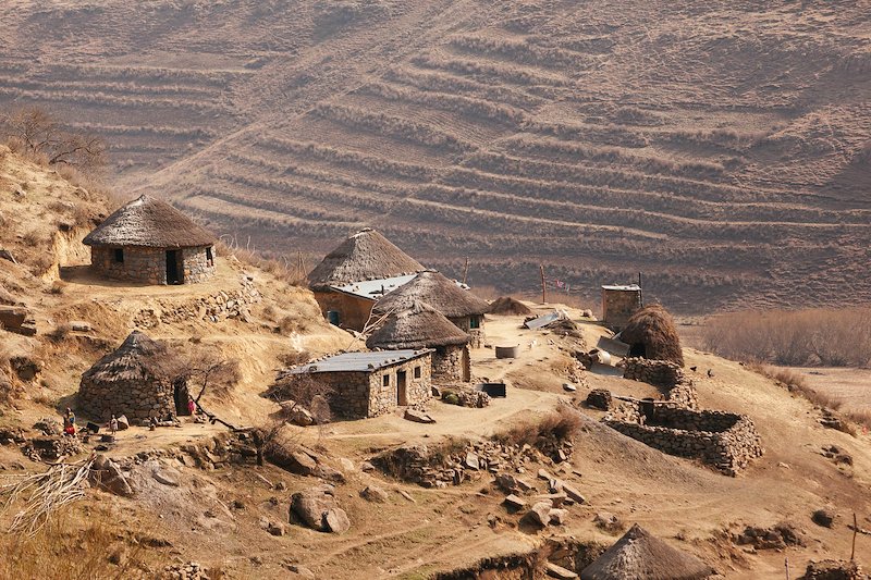 Traditional round 'Mokhoro' huts built into the hillside