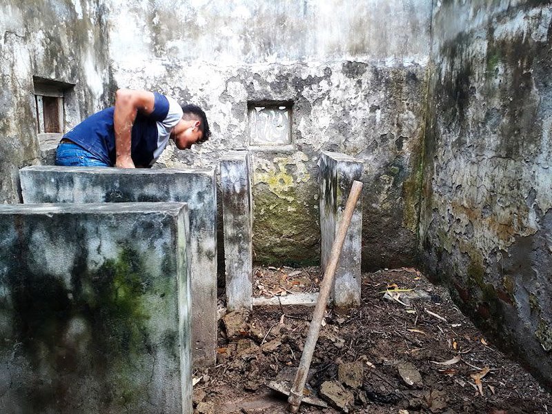 volunteer clearing debris in toilet-2.jpg