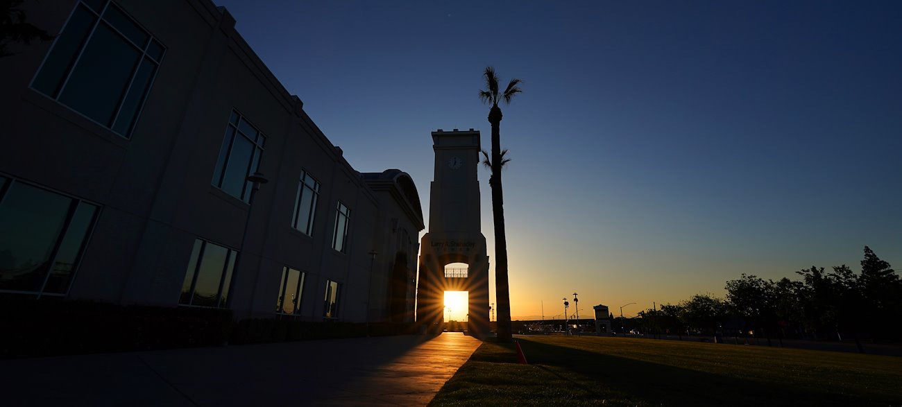 The sunrise shines through the Shehadey Tower at the Save Mart Center.