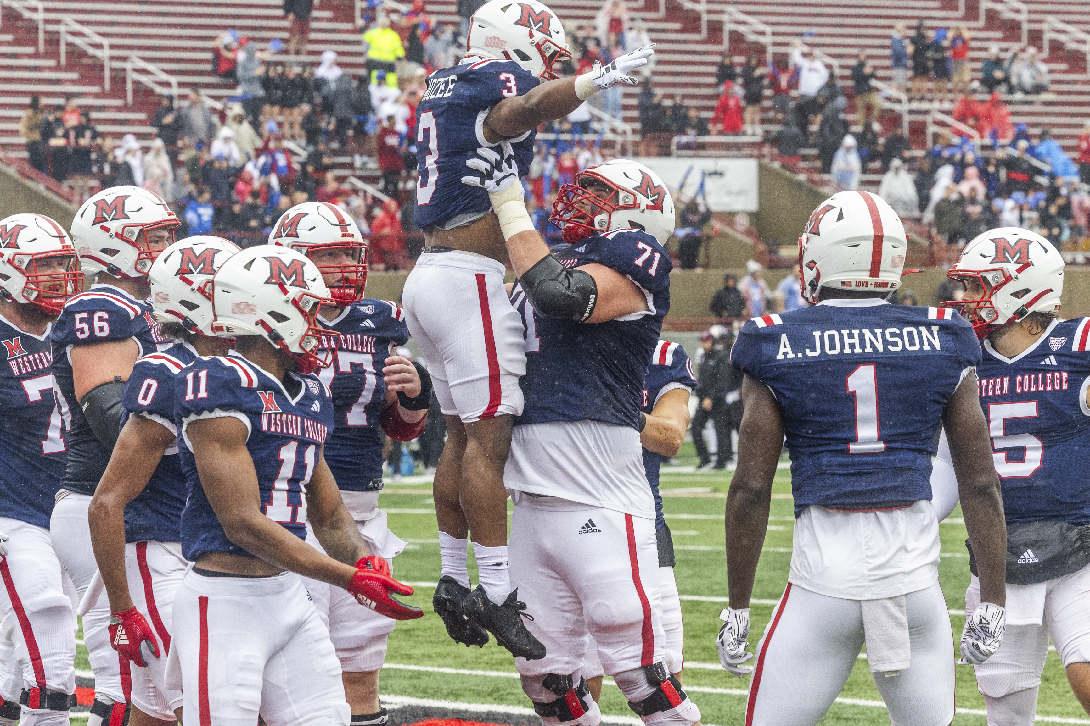 Miami's Keyon Mozee (3) and John Young (71) celebrate a RedHawk touchdown.