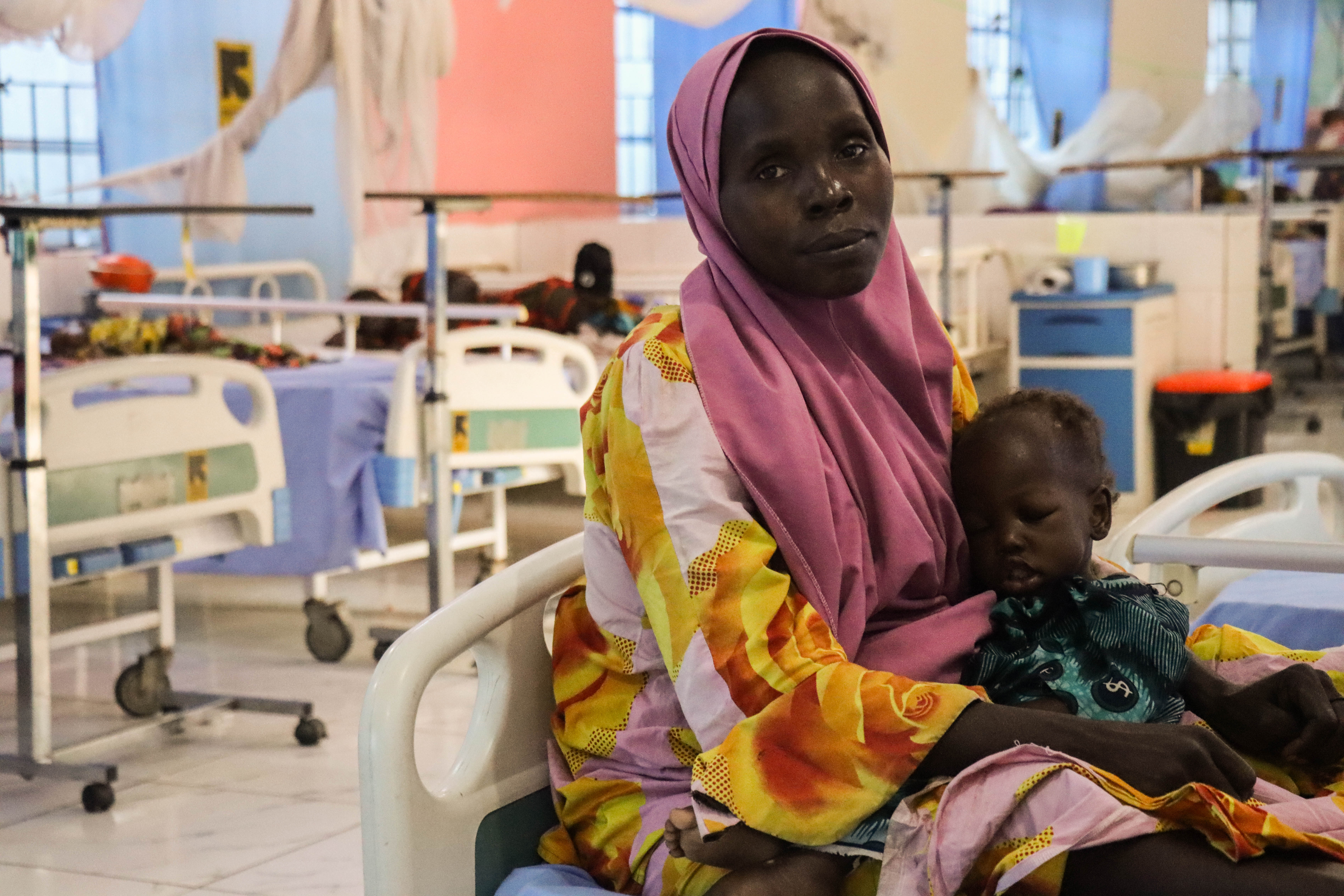 Hauwa Buni Bukar, 27, holds her daughter, Aisha Modu Jafiya, who is ...