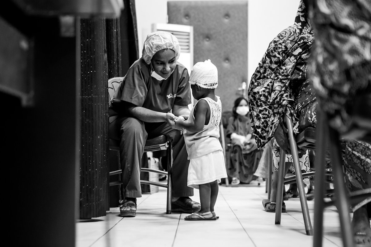 During our gospel presentation, nurse Rakiatou entertains a runaway participant.