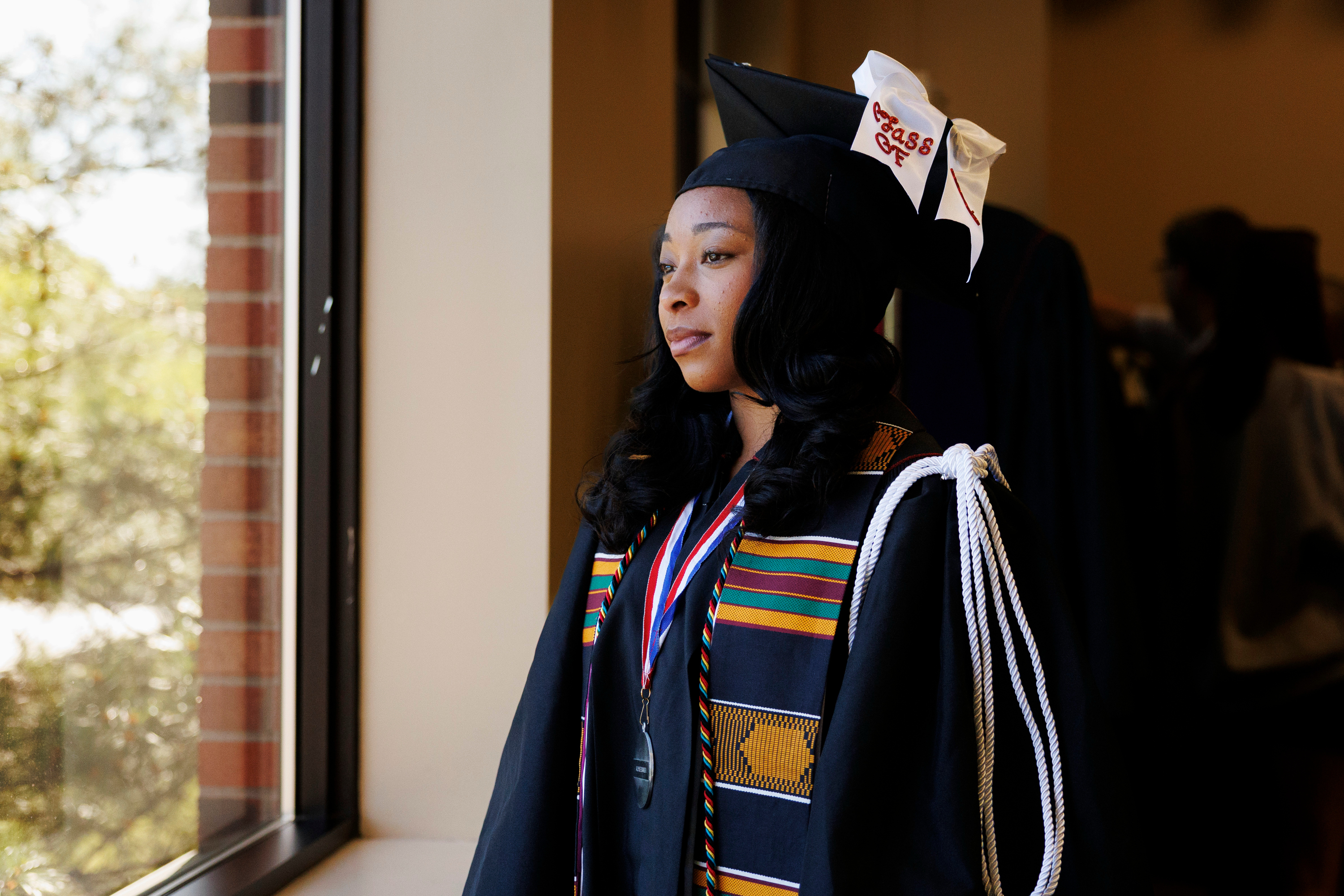 A graduate looks out the window before the IU Southeast Commencement in ...