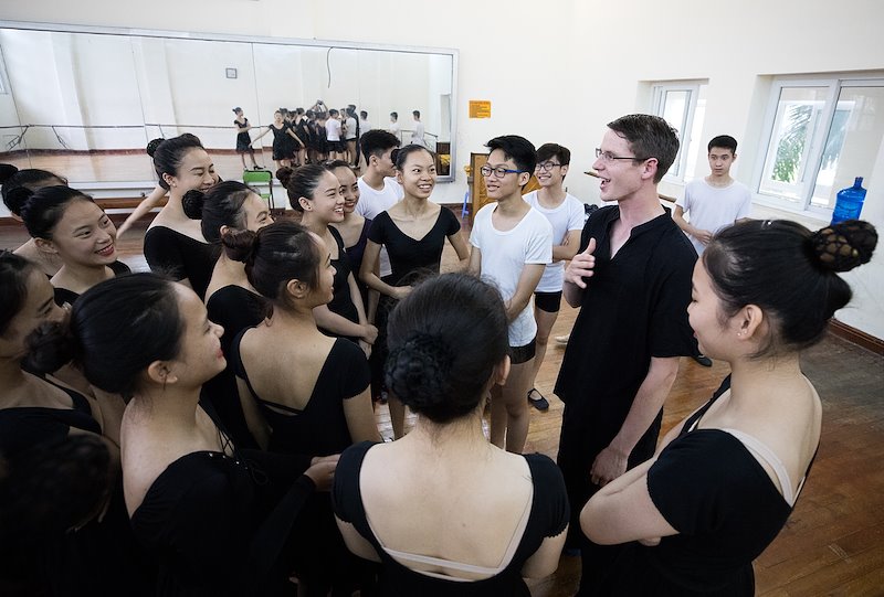 Alex Farnsworth introduces himself to students at the Vietnam Dance College. Photo by Jaren Wilkey/BYU