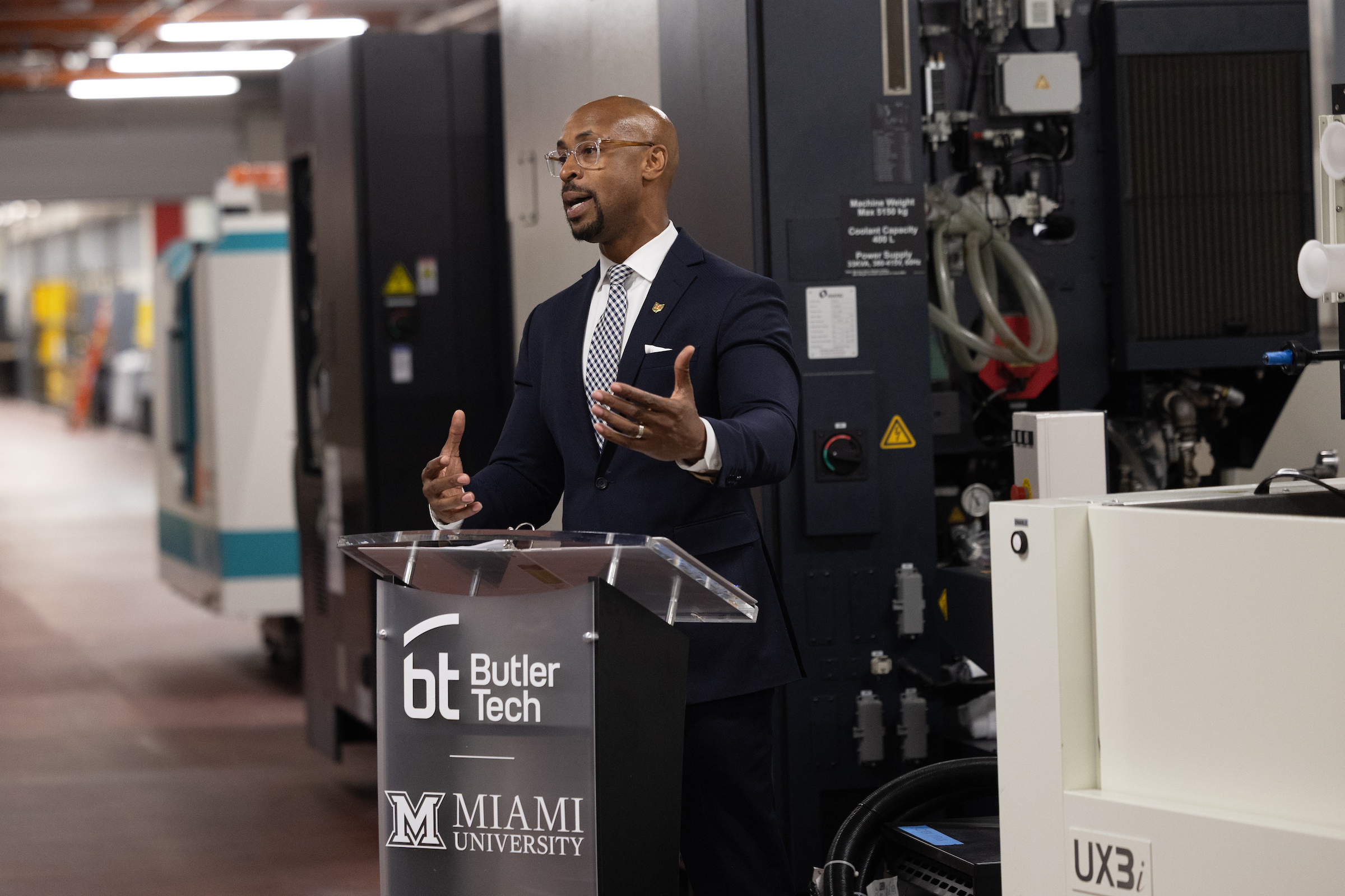 Man speaks at the MU AM HUB dedication, standing at a Butler Tech/Miami ...
