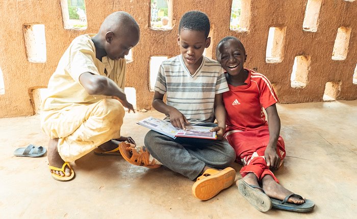 Abel (right) amuses himself while studying math with his friends.