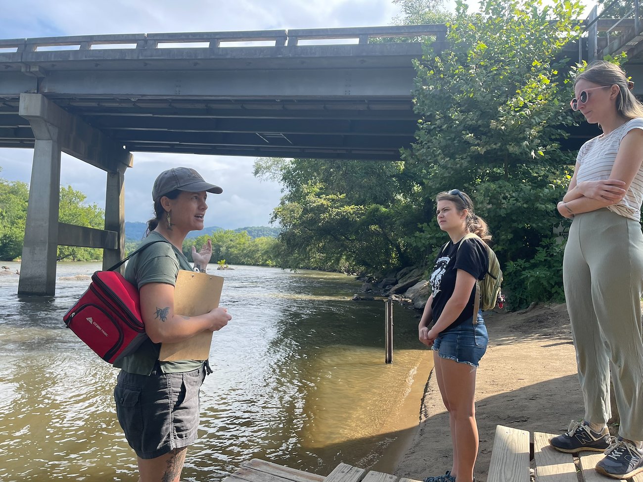 The other fellows join Kari Kvittem at the French Broad River to learn about her research.