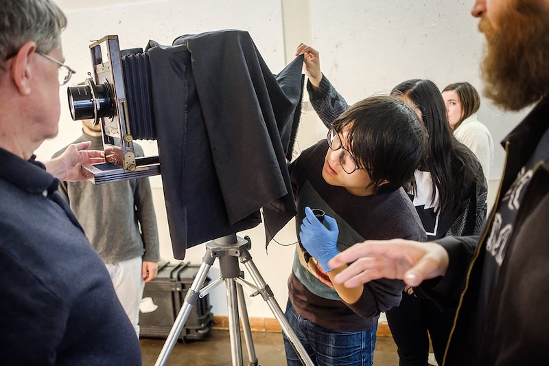Kai Lu ('17) uses the Eastman portrait camera in the makeshift studio in Scales.
