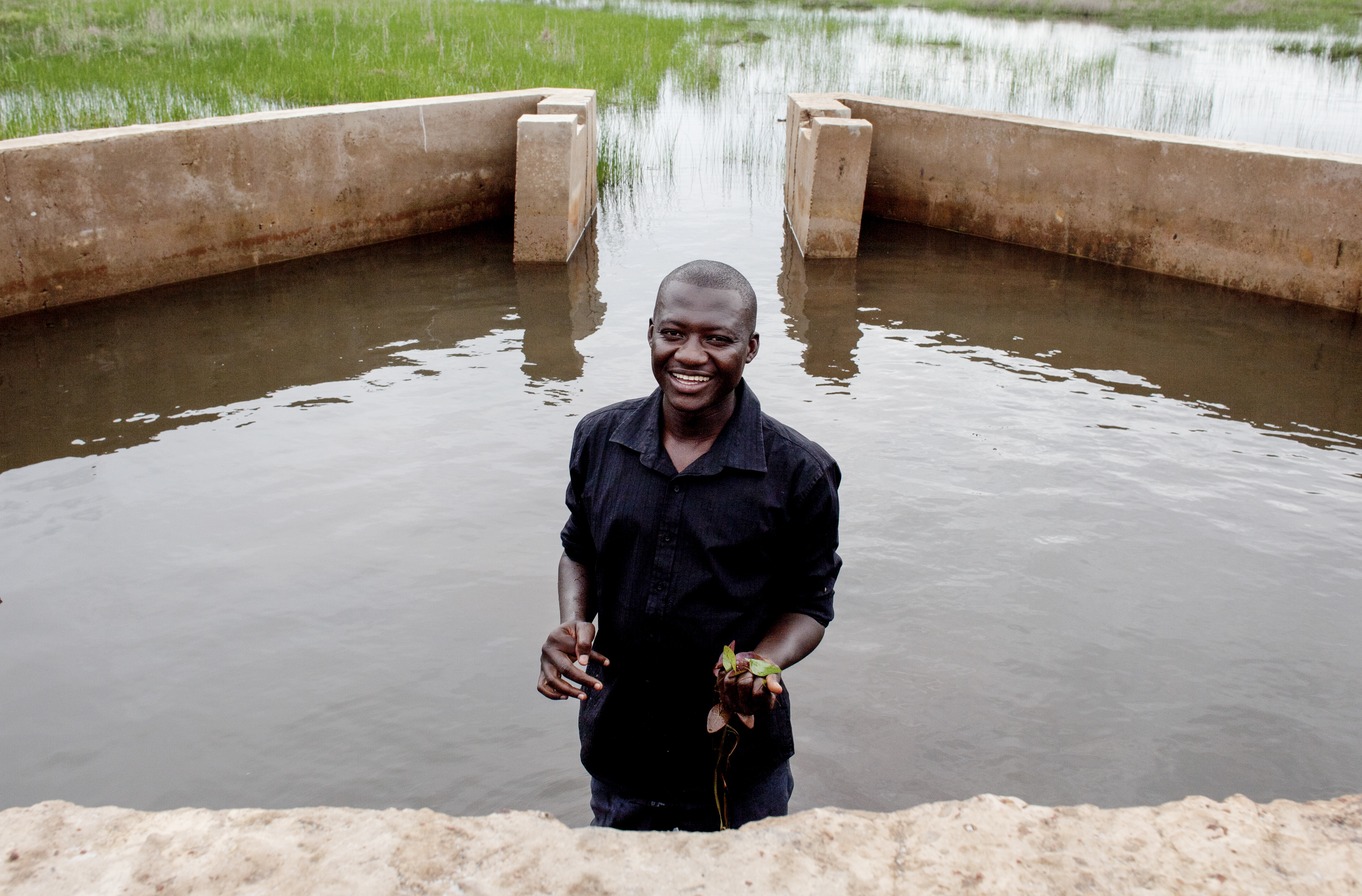 Lamin Jarju of the community-based ActionAid partner ADWAC at the dyke spillway. © Jane Hahn / ActionAid