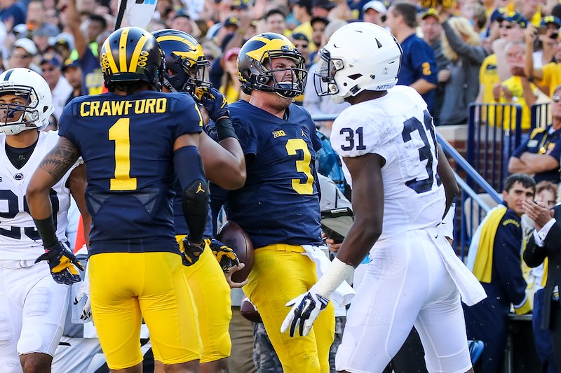 Wilton Speight celebrates scrambling for a first down.