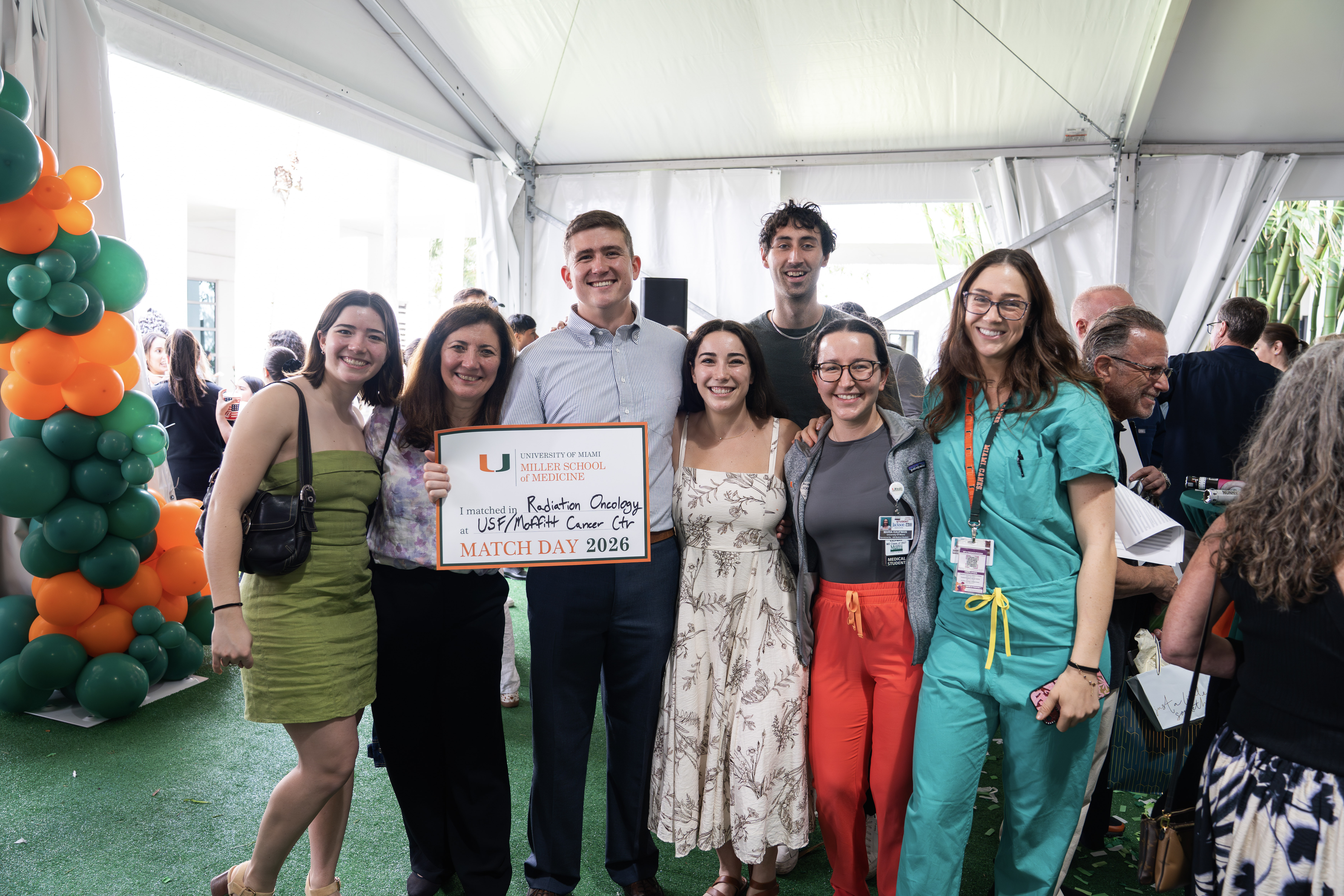 Group poses at Miller School of Medicine Match Day 2026, one holds a sign: