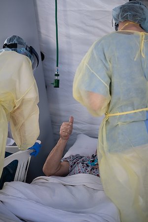 Despite a language barrier, an appreciative patient finds a way to communicate with his nurses at the SP field hospital in Cremona.