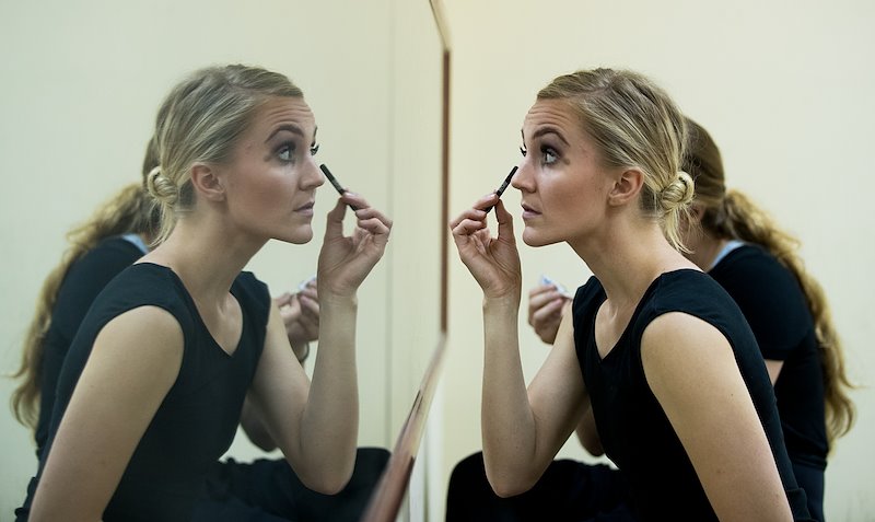 Haley Shepherd applies makeup in preparation for a performance at the Vietnam Dance Academy. Photo by Jaren Wilkey/BYU