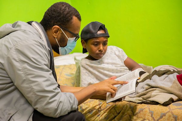 CURE Ethiopia Counselor Nahom and patient Obama spend some time checking out Obama's new Bible courtesy of the Spiritual Staff.