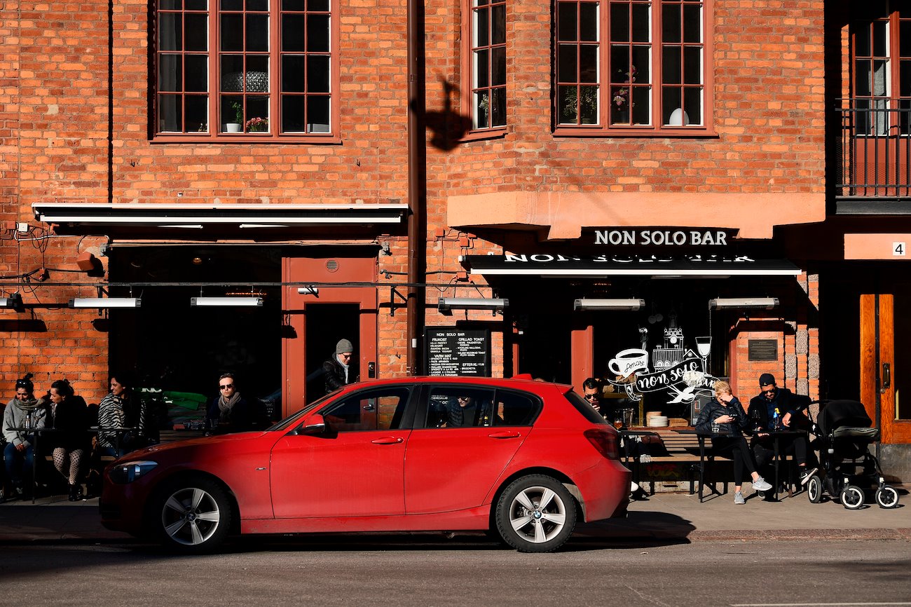 People sit on terrace tables at cafe in Stockholm, Sweden, on Thursday, March 26, 2020. Sweden is starting to look like a global outlier in its response to the coronavirus.