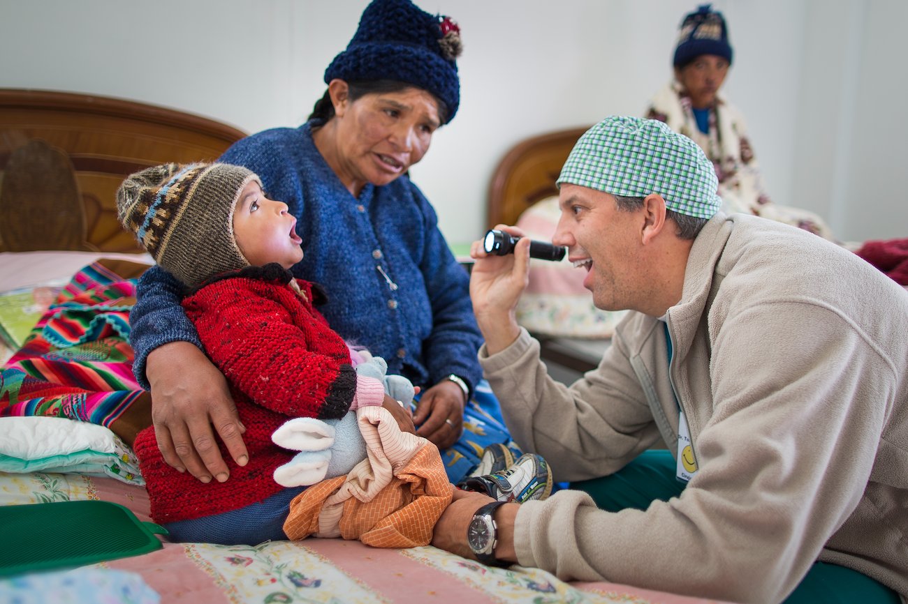Dr. Tom Boeve does a checkup on Ana as her mother Sandusa watches.
