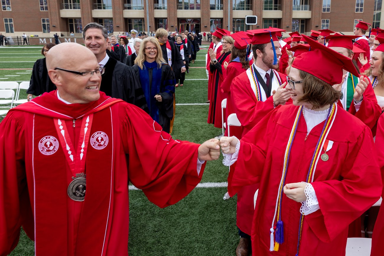 Miami University President Gregory Crawford greets students during the spring commencement ceremony at Yager Stadium.