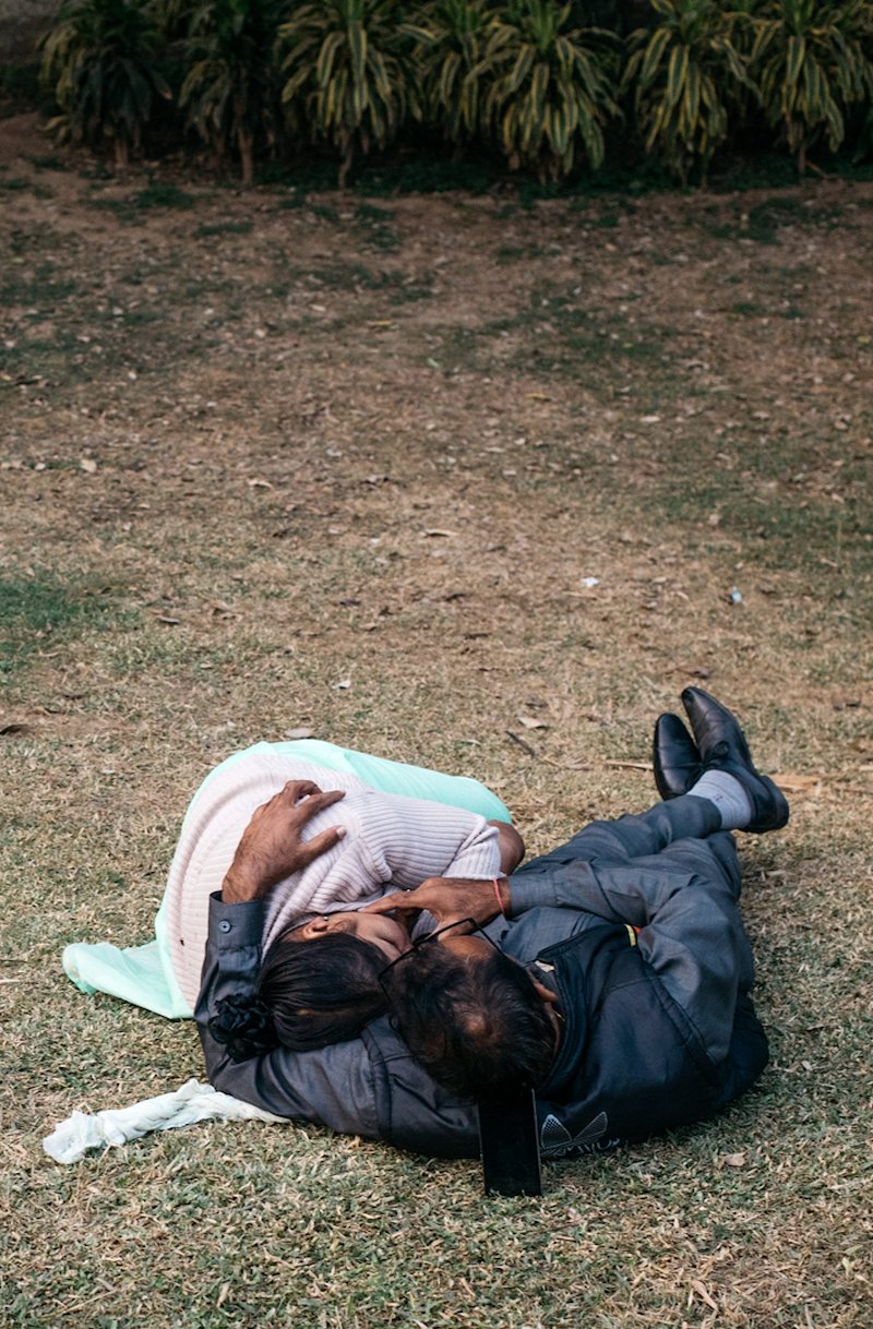 Couples in the park - nice move with the mobile phone head rest