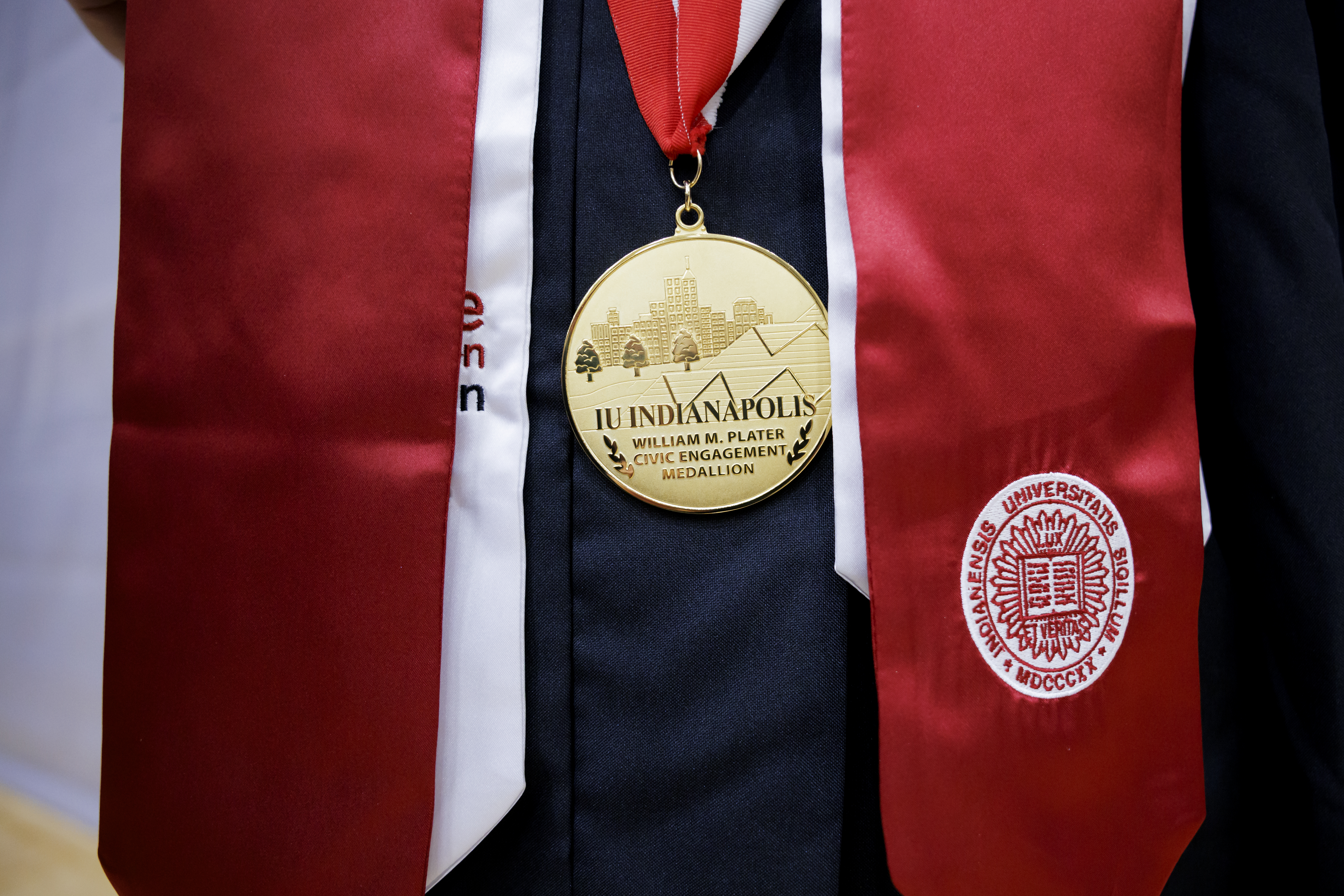 A graduate wears the William M. Plater Civic Engagement Medallion ...