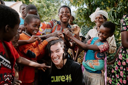 The village kids love playing with Storyteller Alexis' hair.