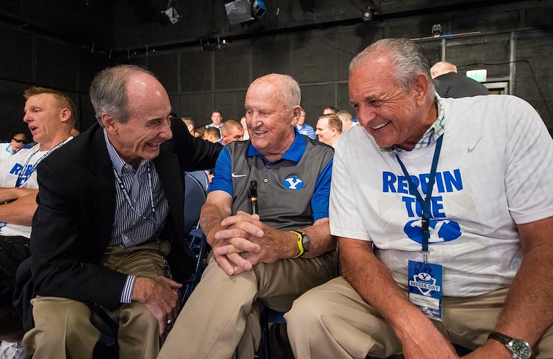 Rondo Fehlberg and Ken Schmidt joke with LaVell at 2016 Football Media Day.