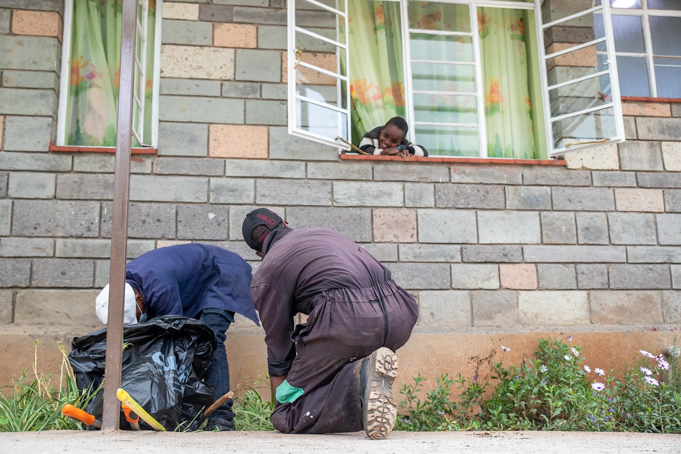 Solomon keeping these gentlemen engaged in a conversation as they tend to the flowers outside the ward.