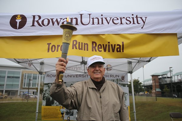 Torch in hand, Peter Oteri '62 took a familiar stance. Oteri ran the last leg of the Trenton-to-Glassboro Torch Run in 1962 and also participated in the 75th anniversary Torch Run in 1998.