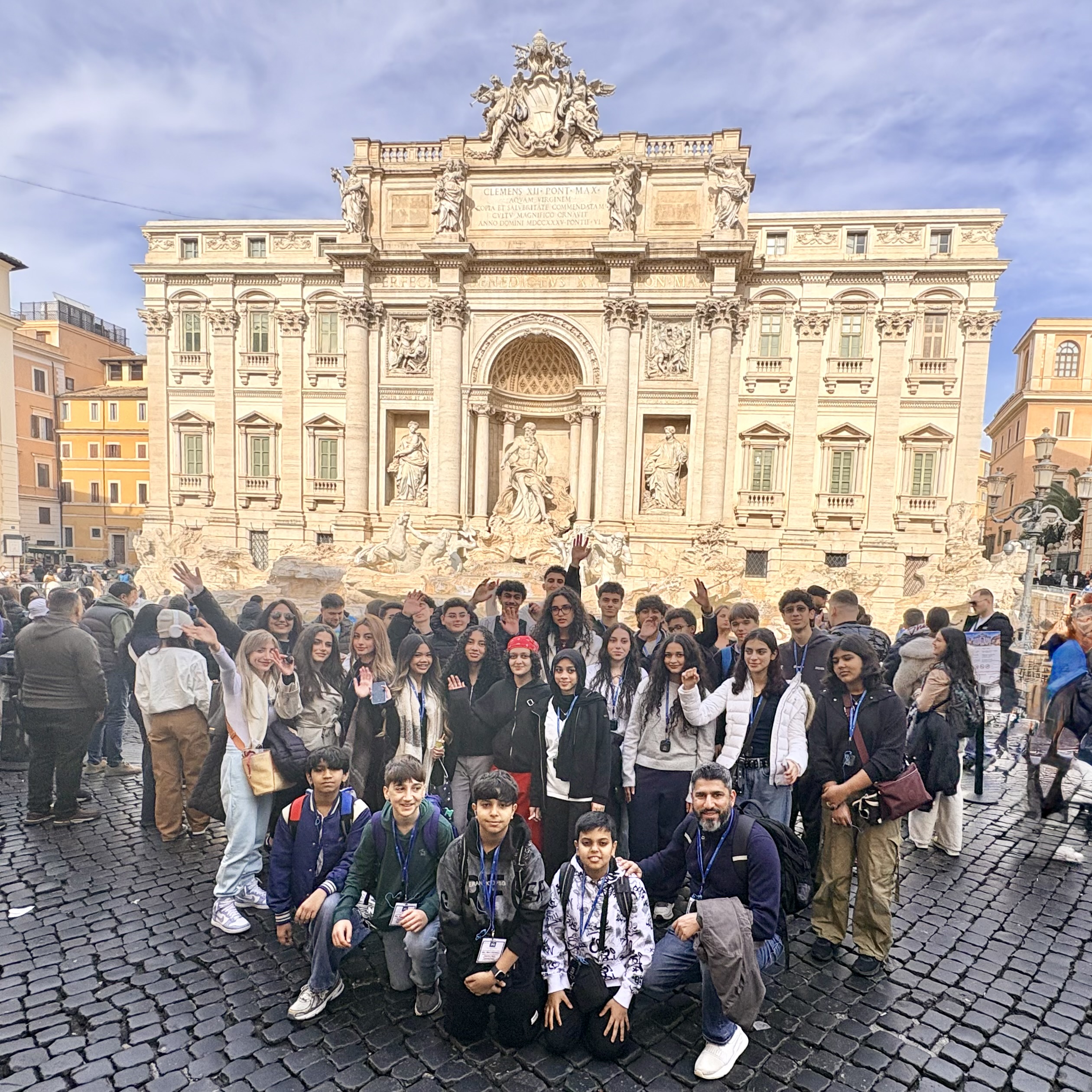 A group of students poses in front of the Trevi Fountain in Rome, Italy ...