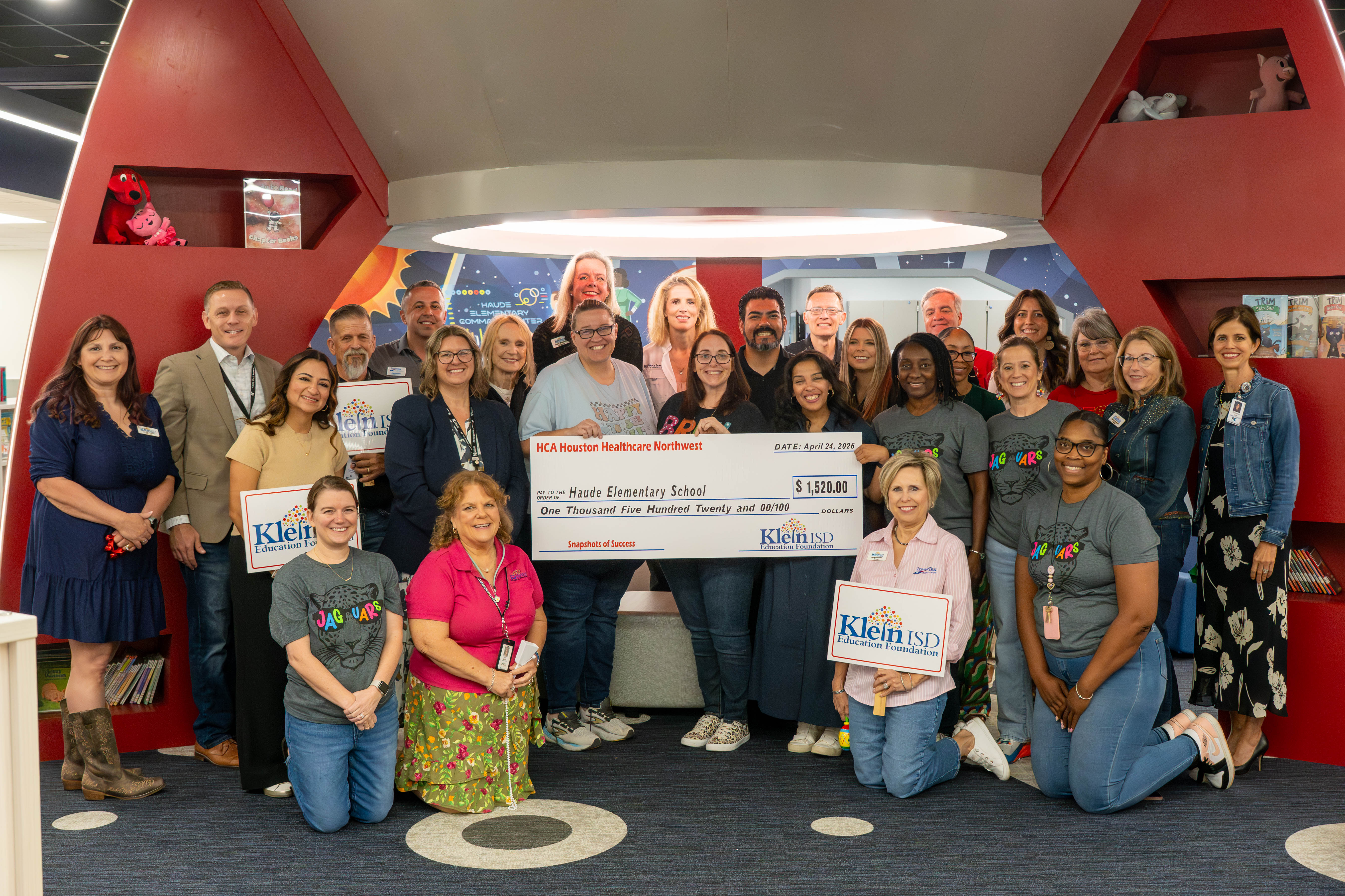 Group of adults pose with oversized check for $1,520.00 made out to ...