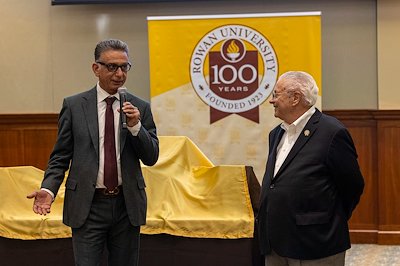 President Houshmand and Tom Gallia, alumnus, former faculty member, administrator and current trustee,  reflected on the significance of the Centennial celebration before unveiling the books.