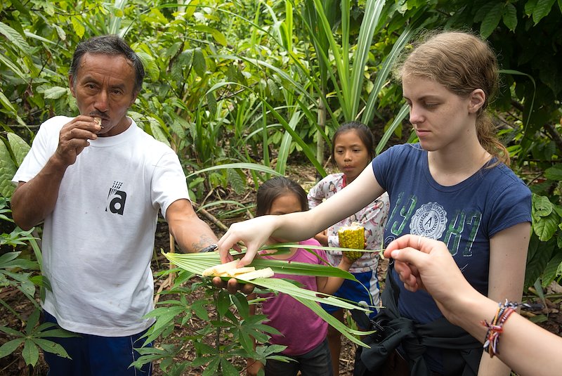 Cezar shares pieces of sugarcane with the students at his farm.