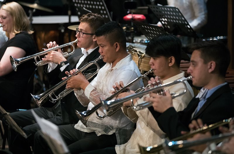 BYU and UP Diliman students play the trumpet during a concert. Photo by Jaren Wilkey/BYU